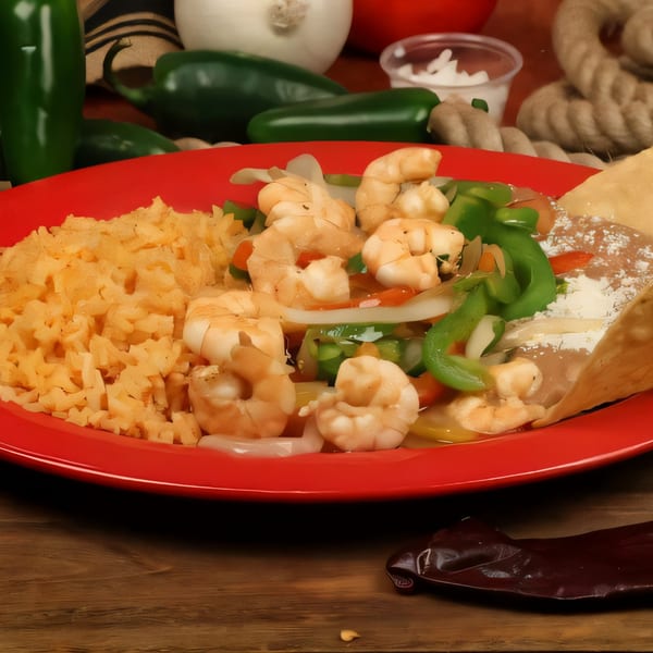 Chilitos Mexican Grill's shrimp fajitas with rice, beans, and vegetables on a red plate.