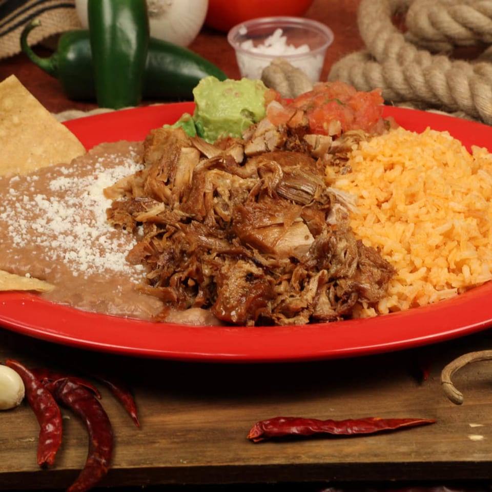 Chilitos Mexican Grill's carnitas plate with rice, refried beans, guacamole, and pico de gallo.